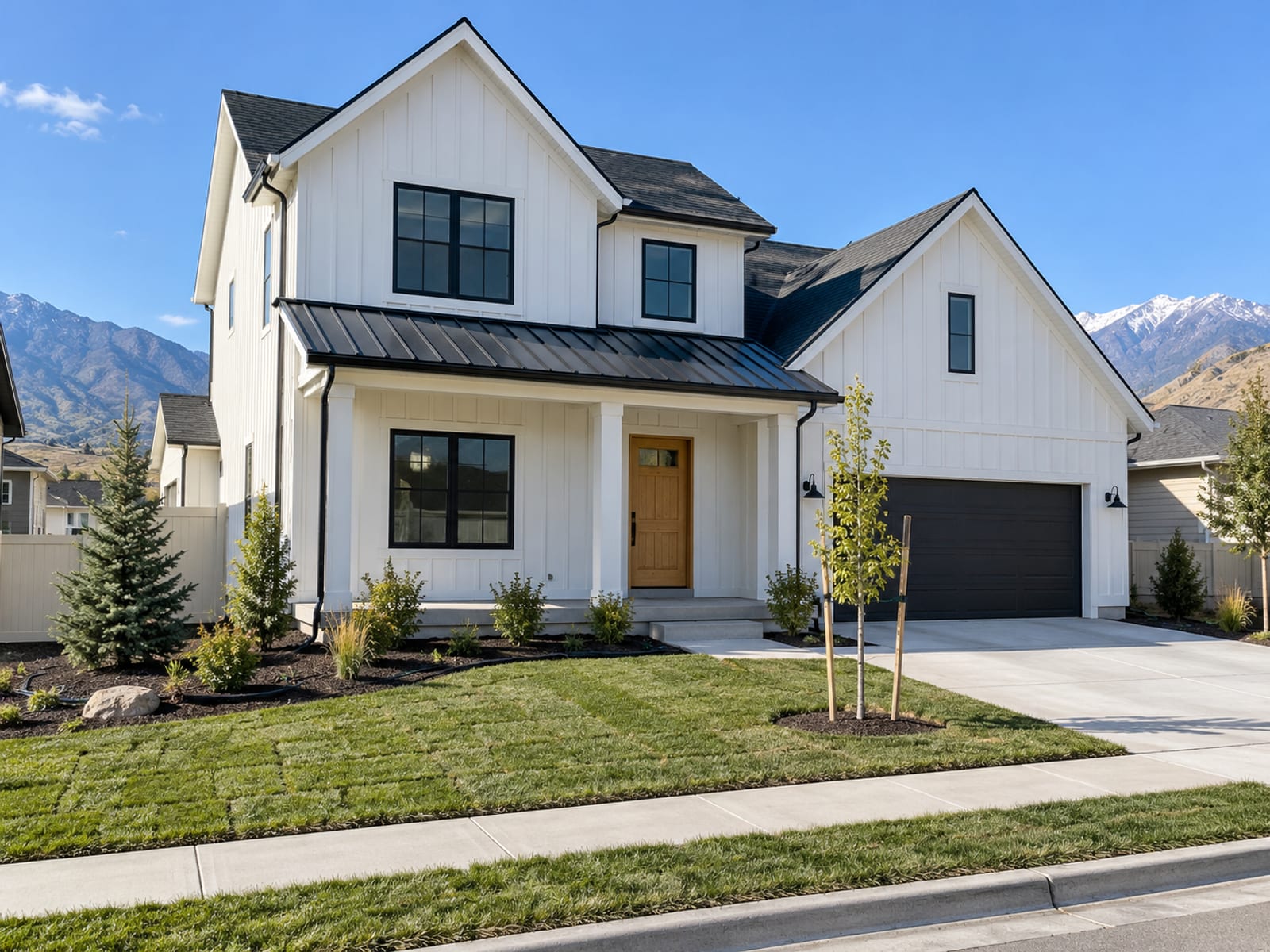 A finished new house exterior with fresh landscaping on a clear day