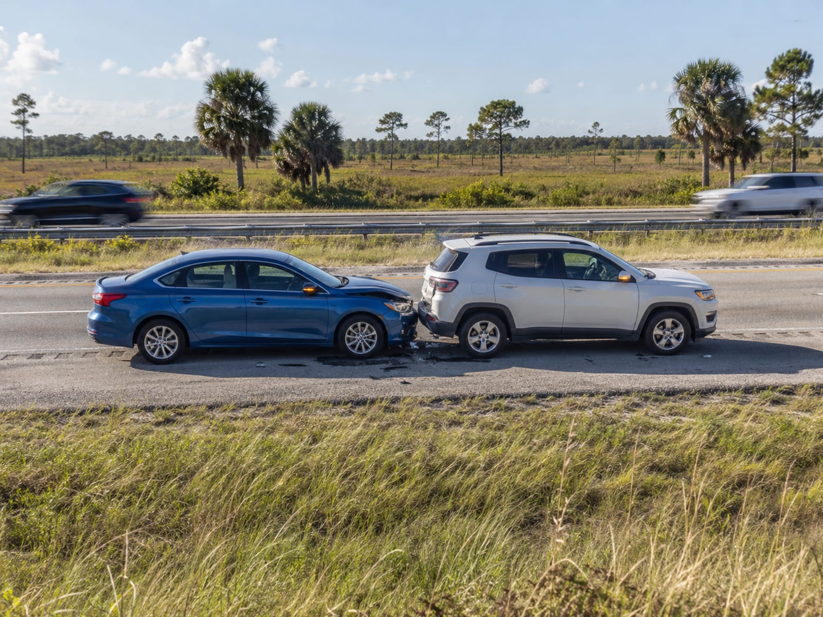 Two cars pulled onto the shoulder of a Florida highway after a minor collision
