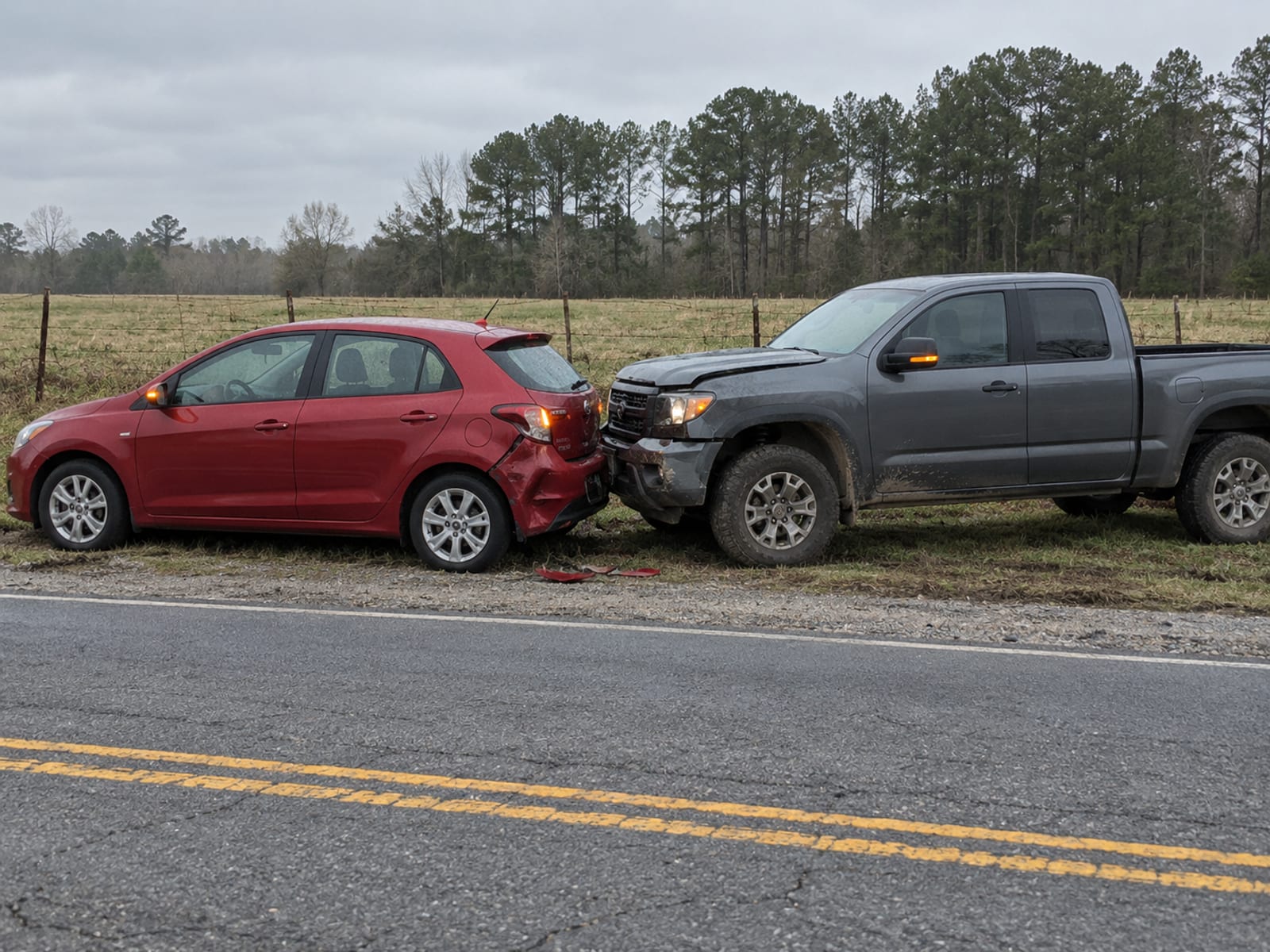 Two cars stopped on a road shoulder after a minor collision, seen from a distance