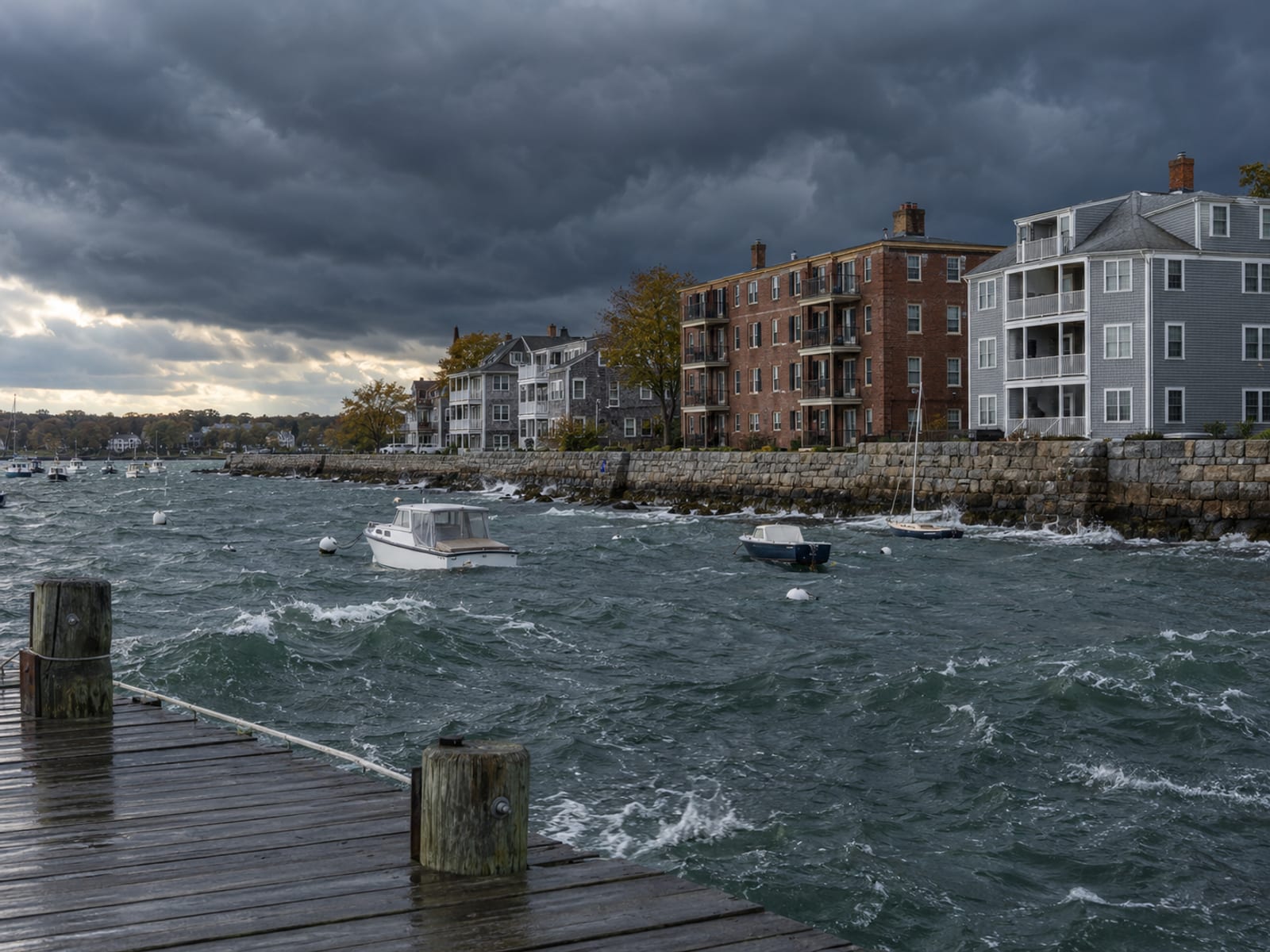 Apartment buildings near a waterfront under heavy storm clouds