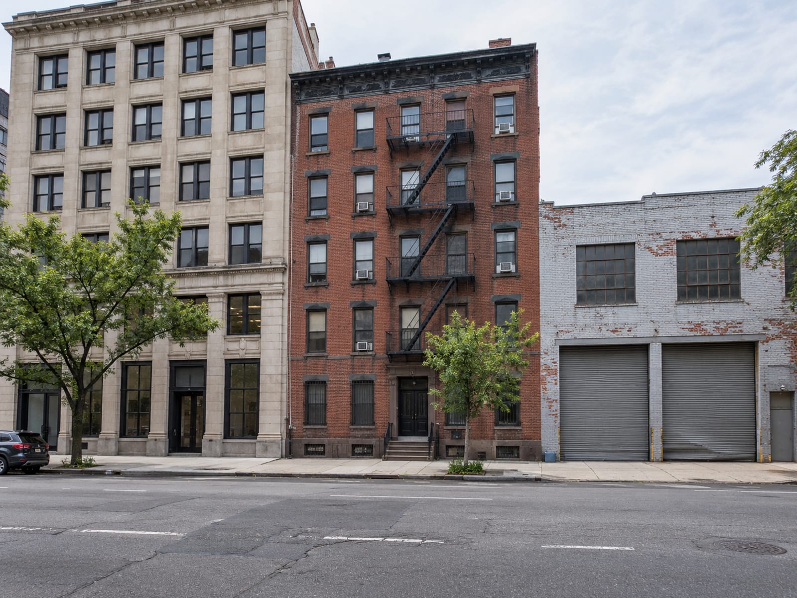An office building, an apartment block and a warehouse standing side by side on a city block